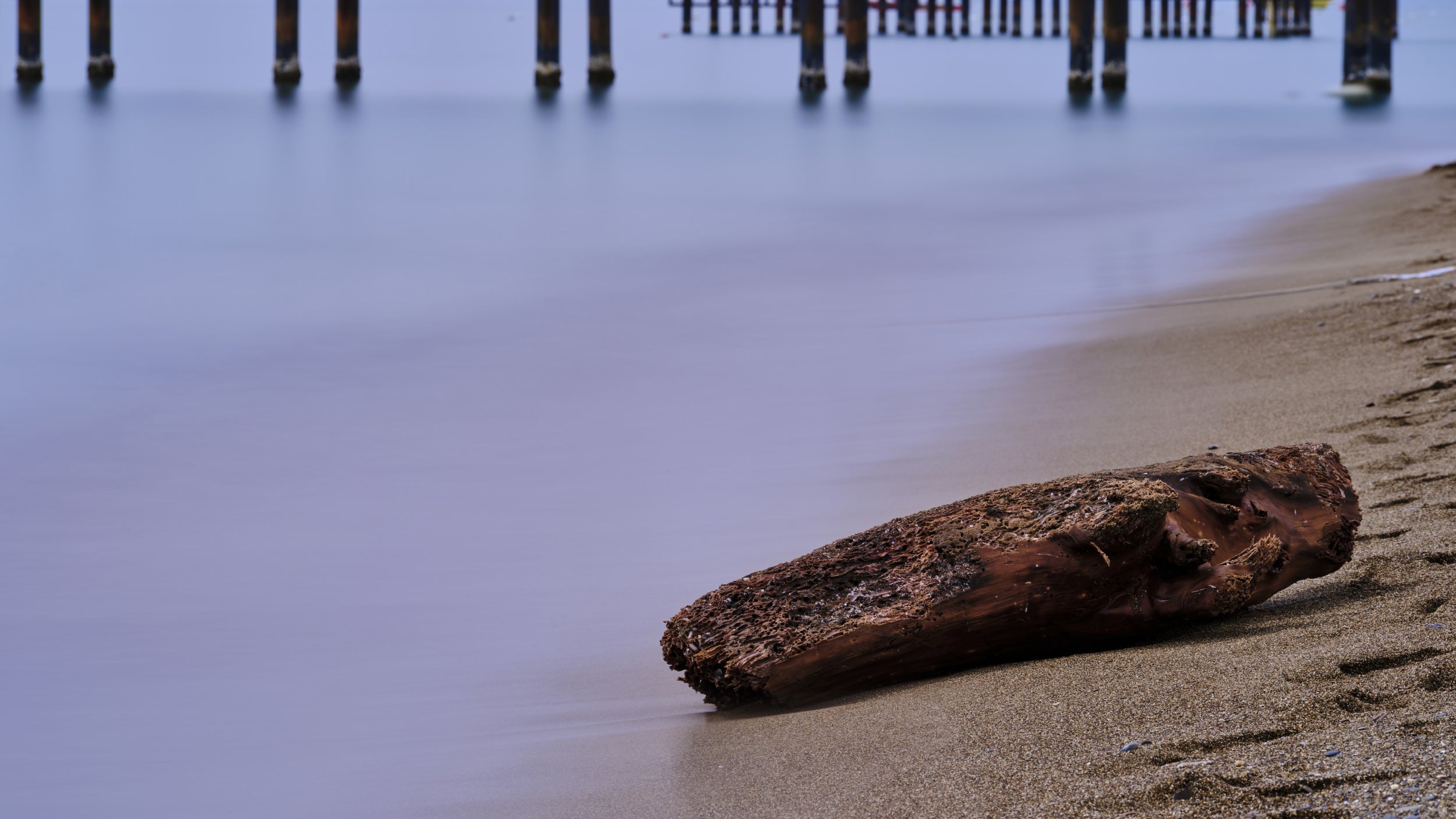 old pier on the beach and long exposure sea waves