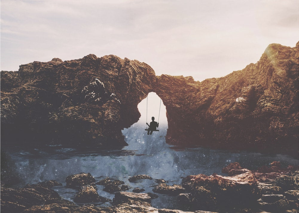 Swinging Under Natural Arch
