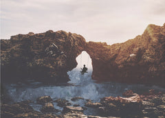 Swinging Under Natural Arch